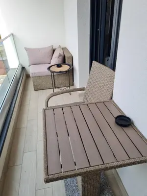 a room with a table and a chair and a couch at Apartman Tina in Vrnjačka Banja