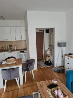 a kitchen with a table and a dining room at Apartman Tina in Vrnjačka Banja