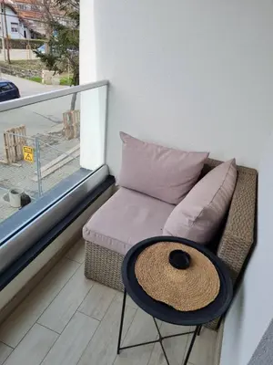 a small room with a couch and a table at Apartman Tina in Vrnjačka Banja