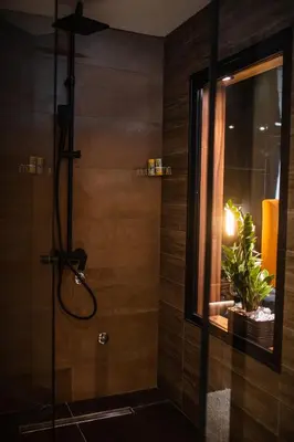 a bathroom with a shower with a glass door at MaLux Nis in Niš