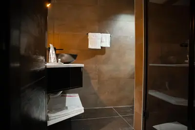 a bathroom with a sink and a shower at MaLux Nis in Niš