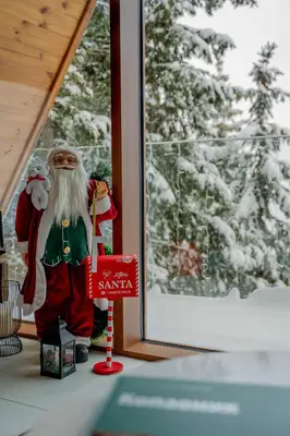 a santa claus figurine sitting on a window sill at Sofia - Mountain Home in Kopaonik