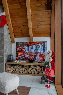 a room with a fireplace with a picture on the wall at Sofia - Mountain Home in Kopaonik