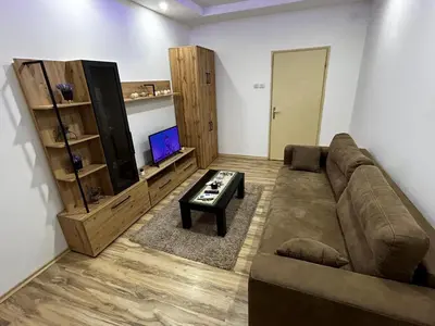 a living room with a couch and a tv at Mance apartments in Paraćin