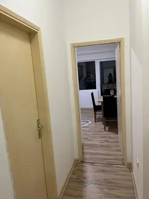 a hallway leading to a dining room with a table at Mance apartments in Paraćin