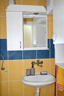 a bathroom with a sink and a mirror at Apartmani Tomašević in Paraćin