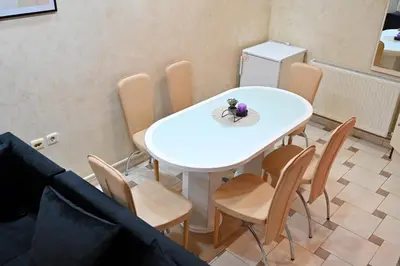 a white table and chairs in a room at Apartmani Tomašević in Paraćin