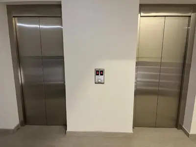 two metal elevators in a building with their doors open at Magija in Vrnjačka Banja