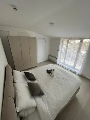 a large white bed in a room with a window at Sunrise Apartman Kopaonik in Cajetina