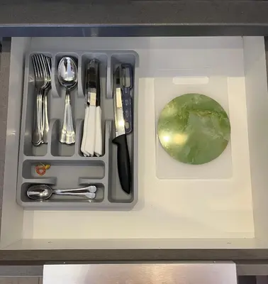 a tray of utensils sitting on top of a counter at Sunrise Apartman Kopaonik in Cajetina