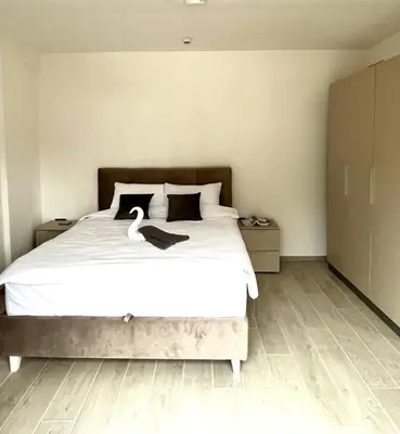 a bedroom with a bed with a swan on it at Sunrise Apartman Kopaonik in Cajetina