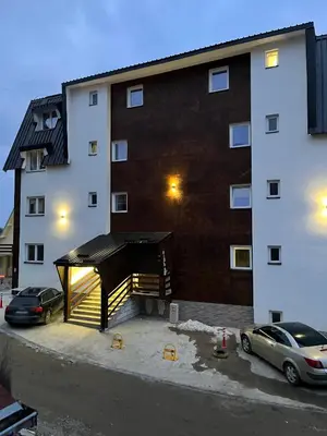 a large building with a large ramp in a parking lot at Iznad oblaka 2 Apartman 2 in Kopaonik