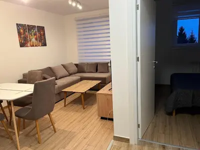 a living room with a couch and a table at Iznad oblaka 2 Apartman 2 in Kopaonik