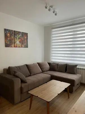 a living room with a couch and a coffee table at Iznad oblaka 2 Apartman 2 in Kopaonik