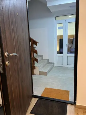 a door leading into a hallway with a staircase at Iznad oblaka 2 Apartman 2 in Kopaonik