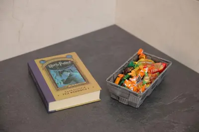 a book sitting next to a container of food next to a book at Soho in Vrnjačka Banja