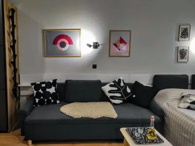 a living room with a couch with pillows at Apartman SPEEDY Gondola in Brzeće