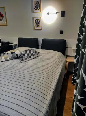 a bedroom with a bed with a striped blanket at Apartman SPEEDY Gondola in Brzeće