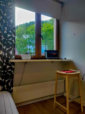 a room with a table and a laptop on a window at Apartman SPEEDY Gondola in Brzeće