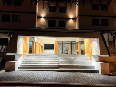 a set of stairs leading to a building at night at Apartman SPEEDY Gondola in Brzeće