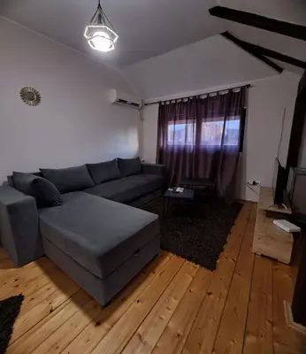a living room with a couch and a television at Sofi in Niš