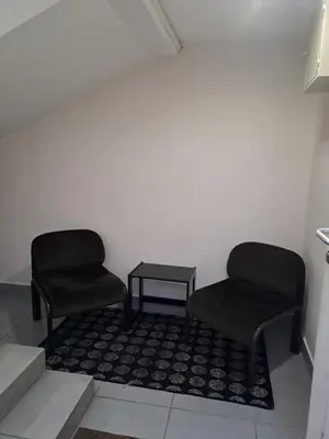 two chairs and a table in a room at Sofi in Niš