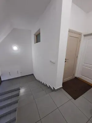 an empty room with a door and a tile floor at Sofi in Niš