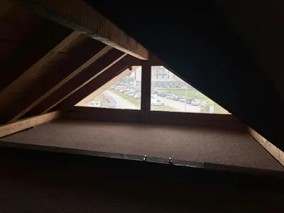 a room with a window in a attic at Sofi in Niš