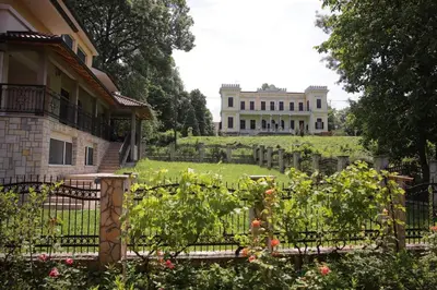 a house with a garden in front of a building at Soho 1 in Vrnjačka Banja