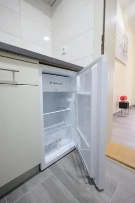 an empty refrigerator with its door open in a kitchen at Soho 1 in Vrnjačka Banja