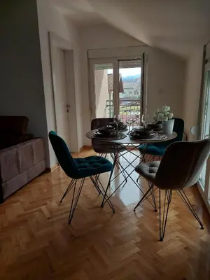 a dining room with a table and chairs in a room at Sunny Paradise in Vrnjačka Banja