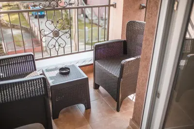 two chairs and a table on a balcony at Sunny Paradise in Vrnjačka Banja