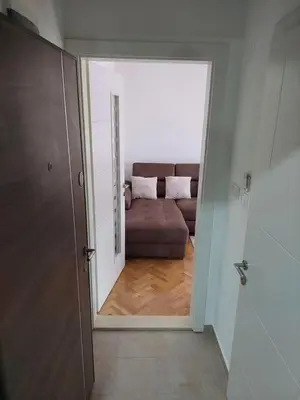 a view of a living room with a couch through a door at Sunny Paradise in Vrnjačka Banja