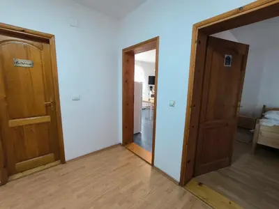 an empty room with two doors and a mirror at Smestaj Dzentlmen in Soko Banja