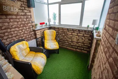a room with two chairs and a brick wall at Fenix1 in Knjazevac.