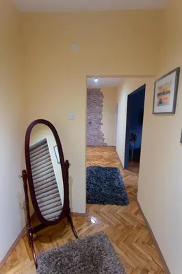 a room with a mirror and two rugs at Fenix1 in Knjazevac.
