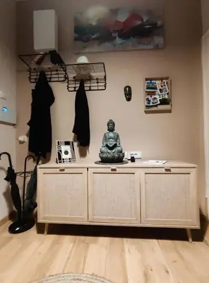 a room with a statue on a desk at Nirvana apartment in Niš