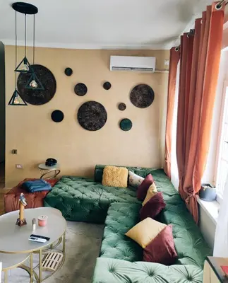 a living room with a green couch and a table at Nirvana apartment in Niš