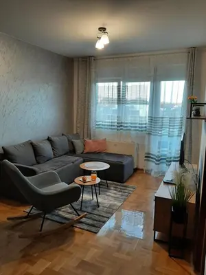 a living room with a couch and a table at Apartman Milic Pirot-Zapadni Kej 10 in Pirot