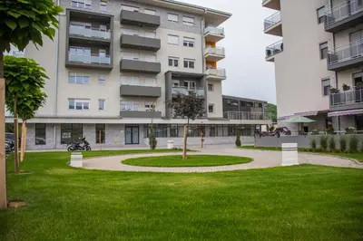 a building with a park in front of it at Apartman Milic Pirot-Zapadni Kej 10 in Pirot