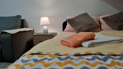 a bed with towels and pillows on it at Apartman Marija in Soko Banja