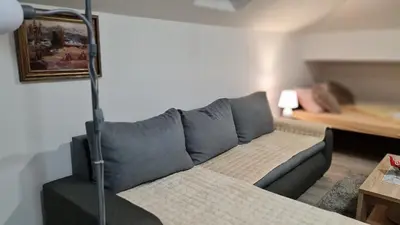 a living room with a couch and a bed at Apartman Marija in Soko Banja