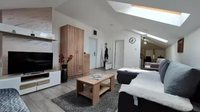 a living room with a couch and a flat screen tv at Apartman Marija in Soko Banja