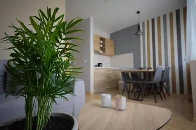 a living room with a table and a potted plant at Apartman Elena 14 in Vrnjačka Banja