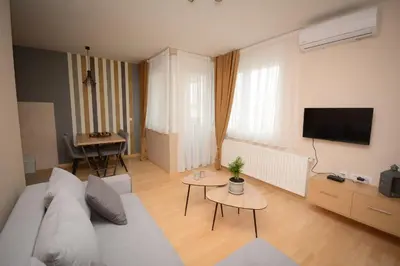 a living room with a couch and a table at Apartman Elena 14 in Vrnjačka Banja
