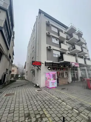 a building with a sign on the side of it at Apartman Elena 14 in Vrnjačka Banja