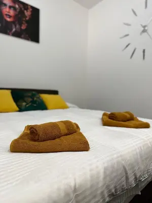 two brown towels sitting on top of a bed at DREAM apartments in Niš