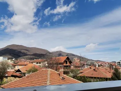 a view from the roof of a town with mountains in the background at Nikolici - Free Parking in Vranje