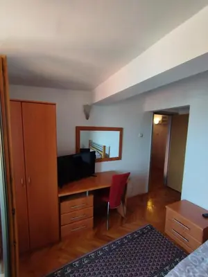 a bedroom with a desk and a red chair at VILA MARKO in Niška Banja