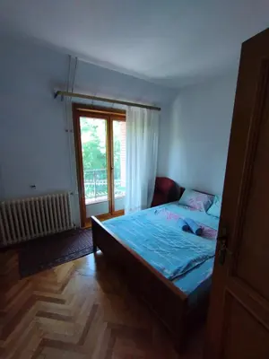 a bedroom with a bed and a large window at VILA MARKO in Niška Banja